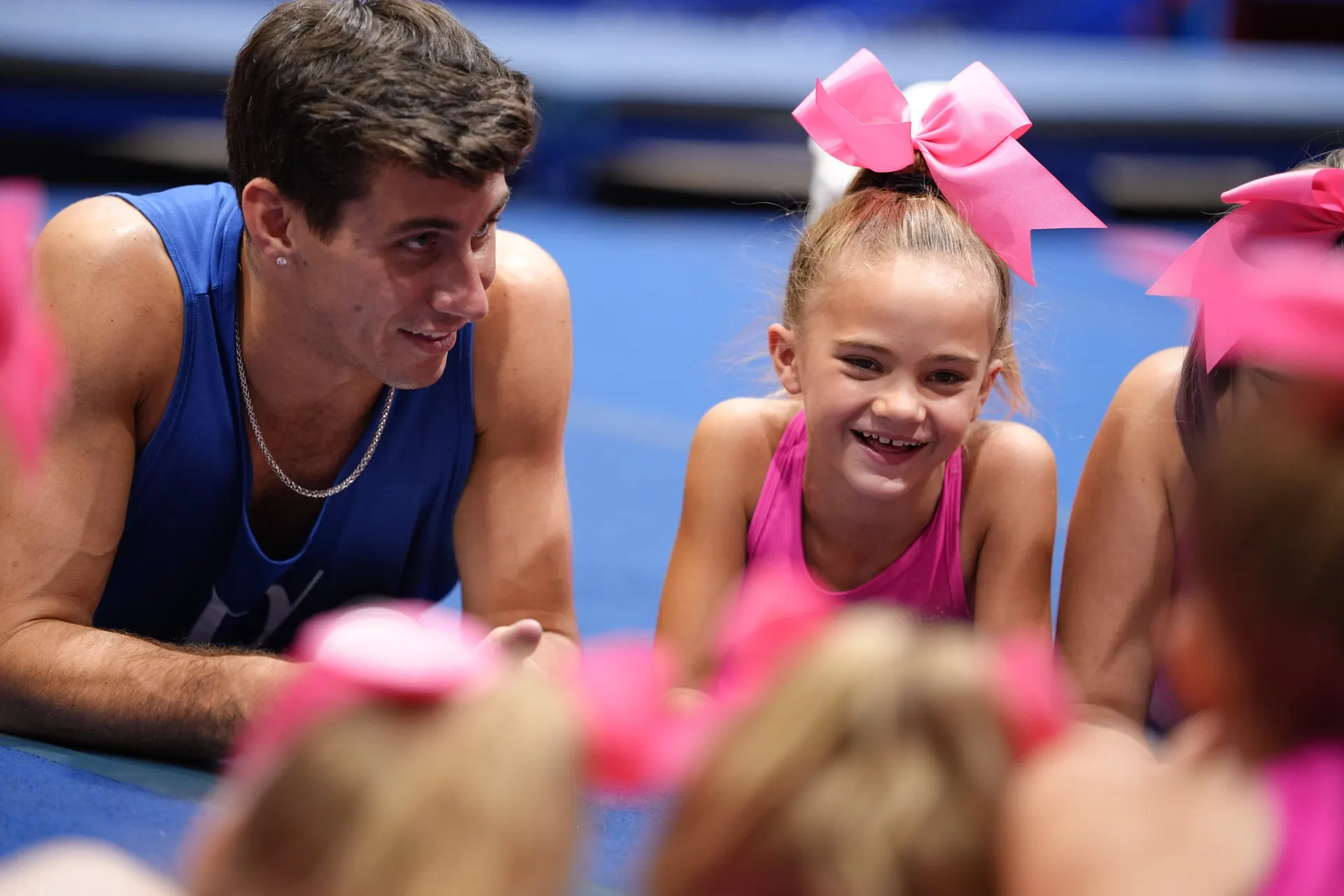 A coach with a smiling young athlete